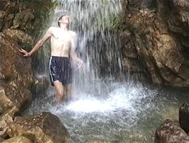 Ryan gets a soaking in the Gordale Scar waterfall